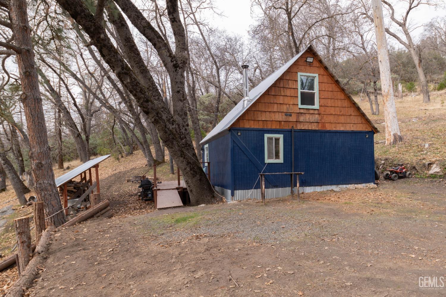 Undisclosed Address Posey, CA 93260 - Photo 18 of 51 a front view of a house with a yard