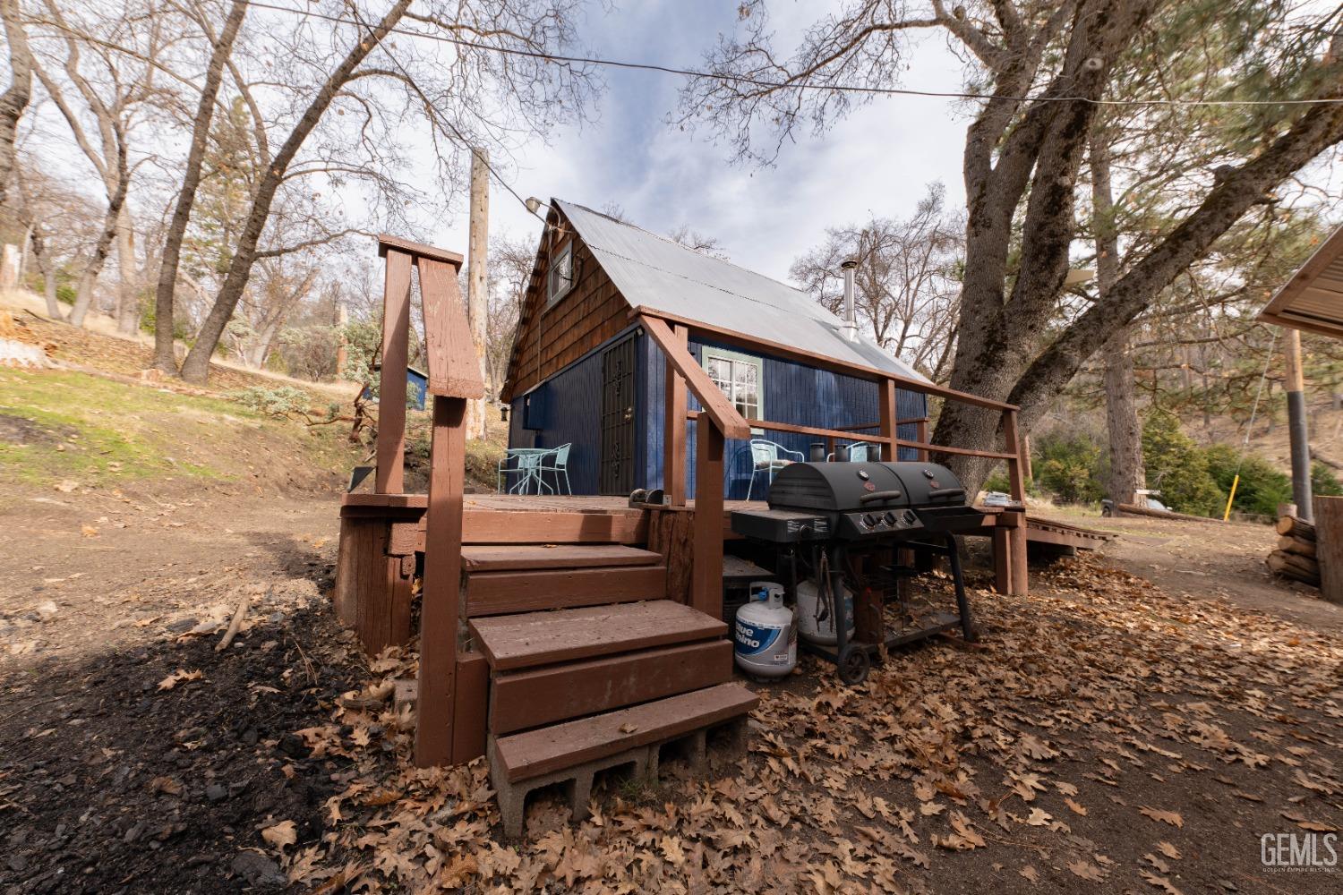 Undisclosed Address Posey, CA 93260 - Photo 2 of 51 a view of a house with a chairs and bench in a yard