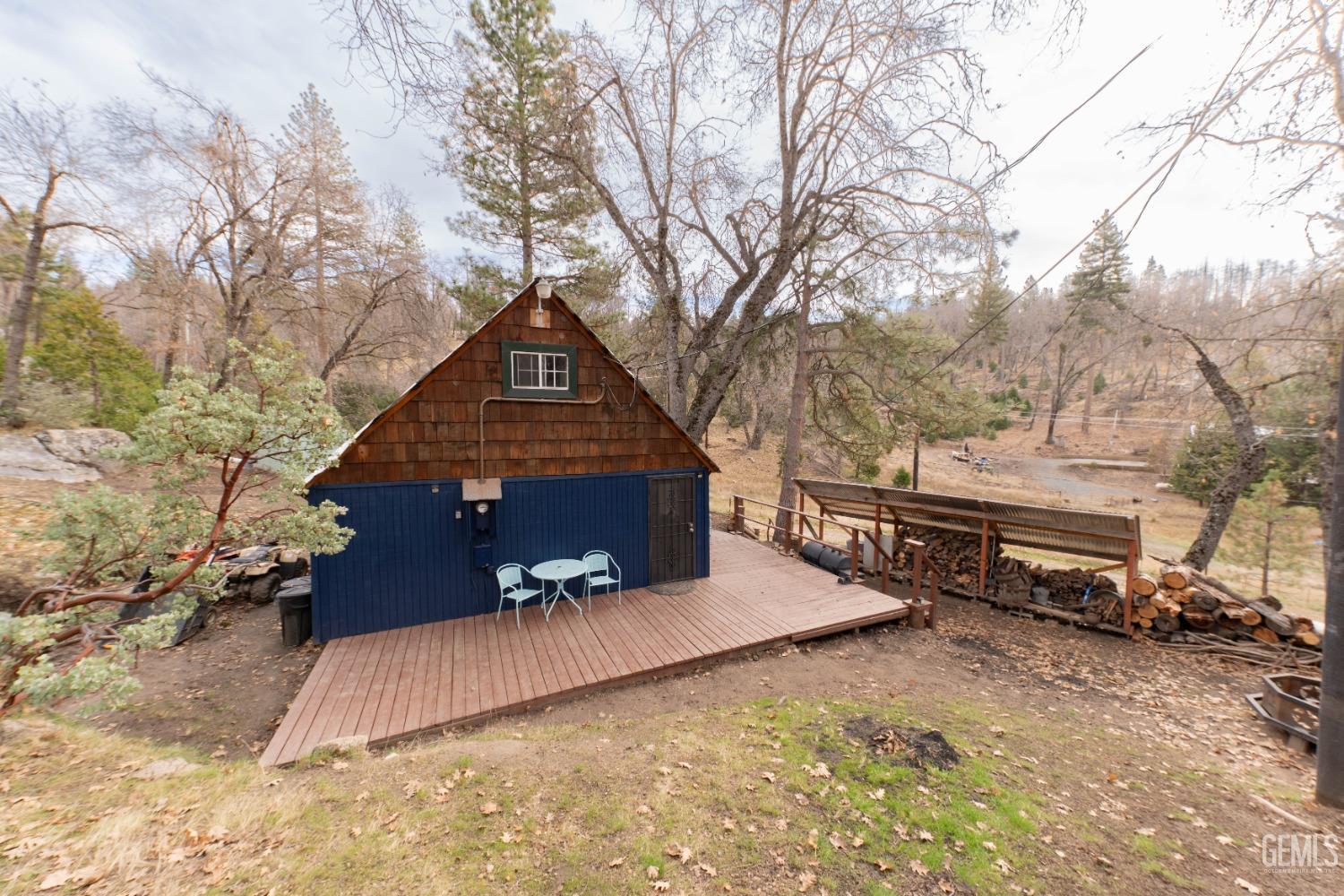 Undisclosed Address Posey, CA 93260 - Photo 21 of 51 a view of a house with a yard covered with snow in the background