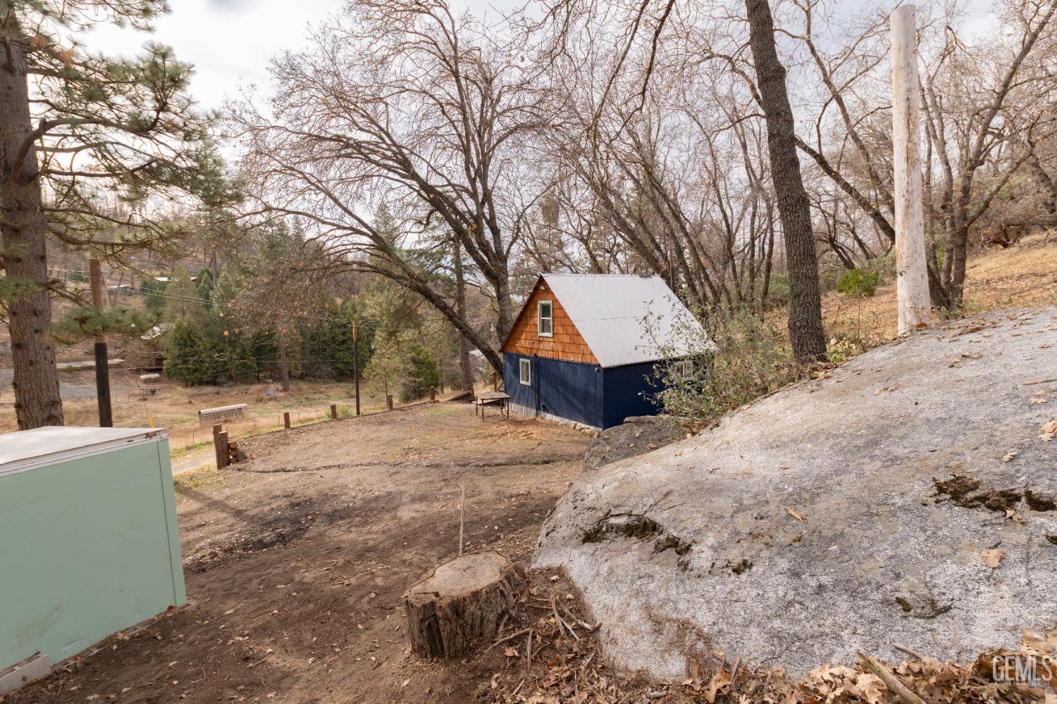 Undisclosed Address Posey, CA 93260 - Photo 26 of 51 a front view of a house with a yard covered in snow