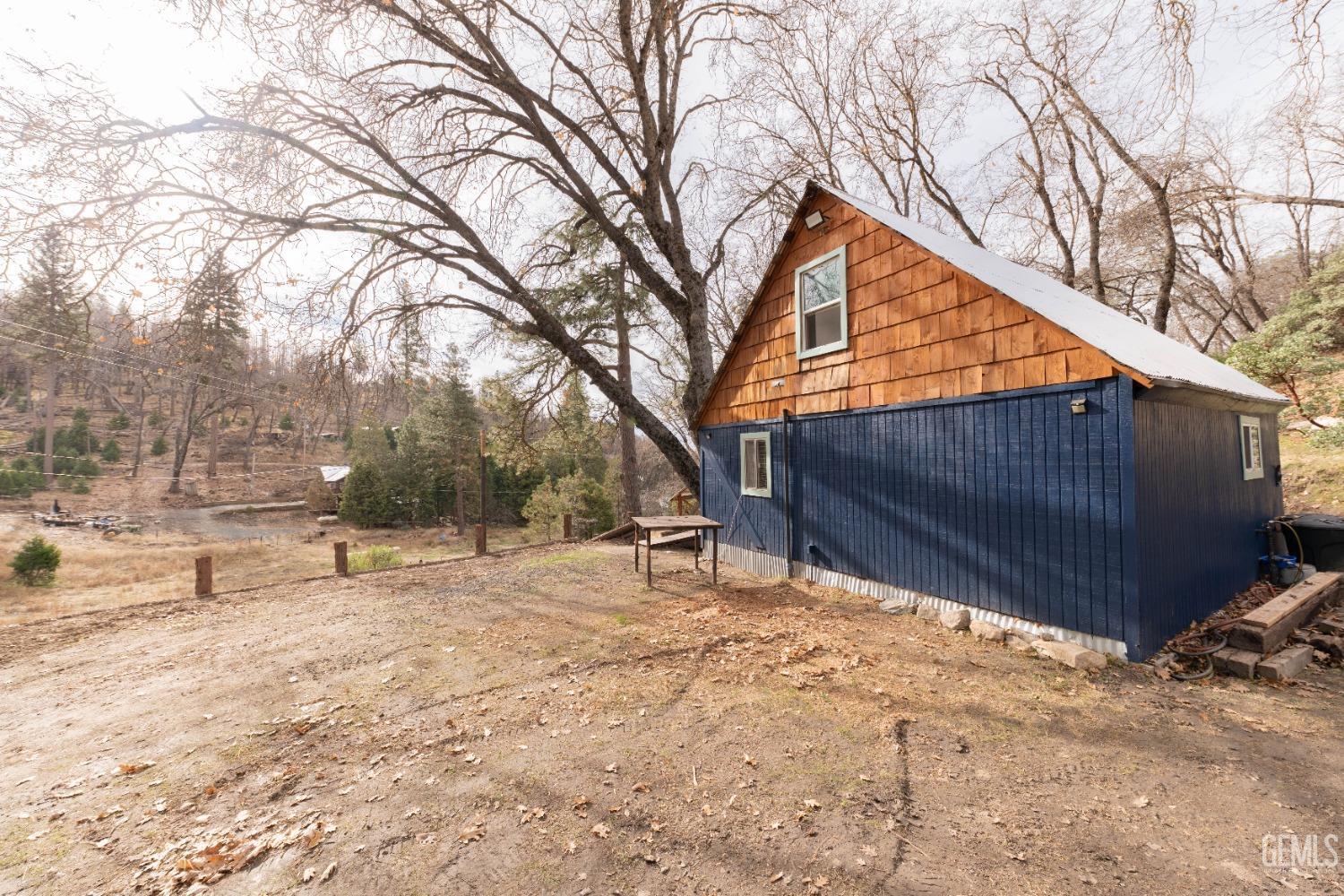 Undisclosed Address Posey, CA 93260 - Photo 28 of 51 a backyard of a house with a large tree