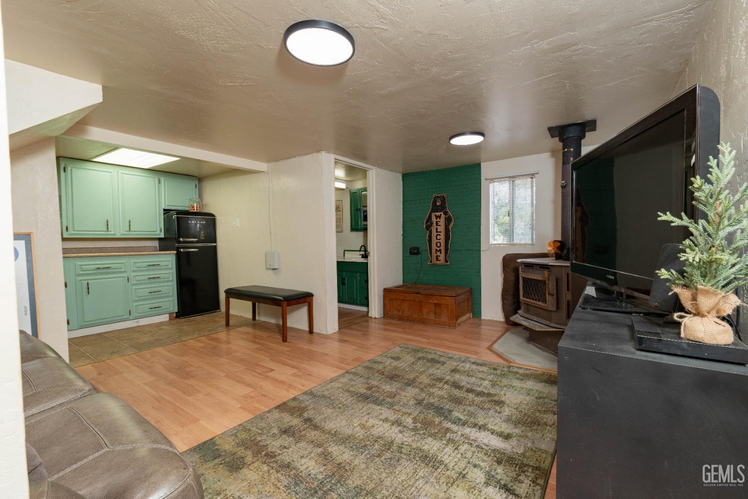 Undisclosed Address Posey, CA 93260 - Photo 35 of 51 a kitchen with stainless steel appliances kitchen island granite countertop a refrigerator and a sink