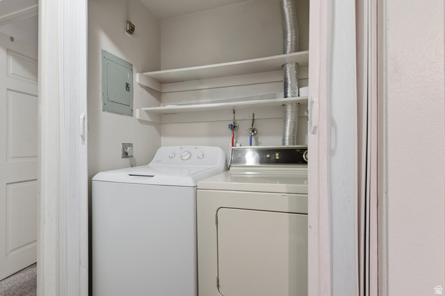 1700 Hickory Lane Provo, UT 84604 - Photo 16 of 20 Dedicated laundry closet featuring a top-loading washing machine, front-loading dryer, and two built-in storage shelves