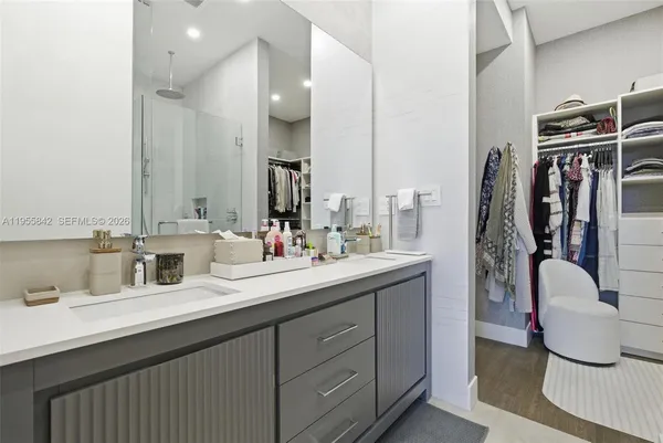 a bathroom with a double vanity sink and a mirror