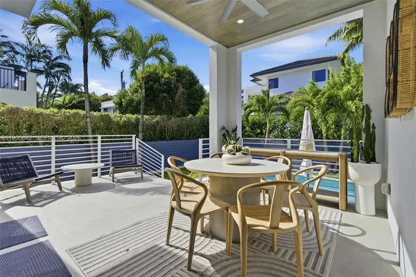 a view of a patio with table and chairs and potted plants