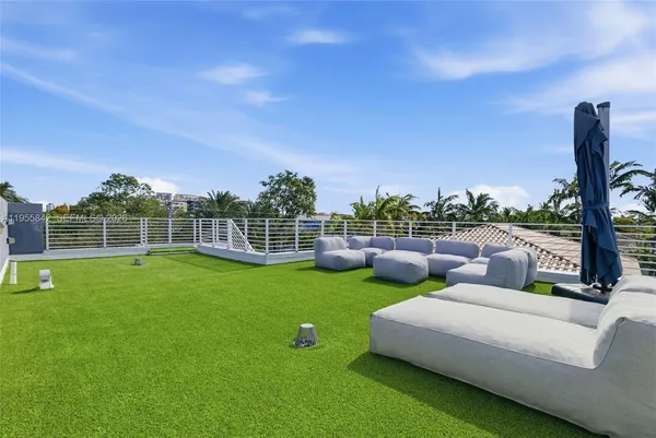 a view of a garden with lawn chairs