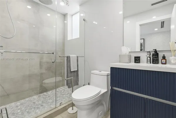 a bathroom with a toilet sink and shower