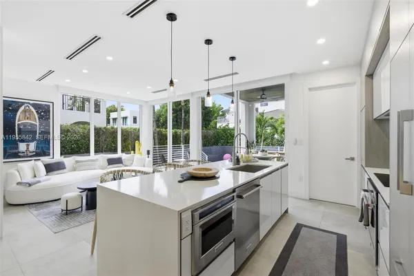 a open kitchen with stainless steel appliances granite countertop a sink and a refrigerator
