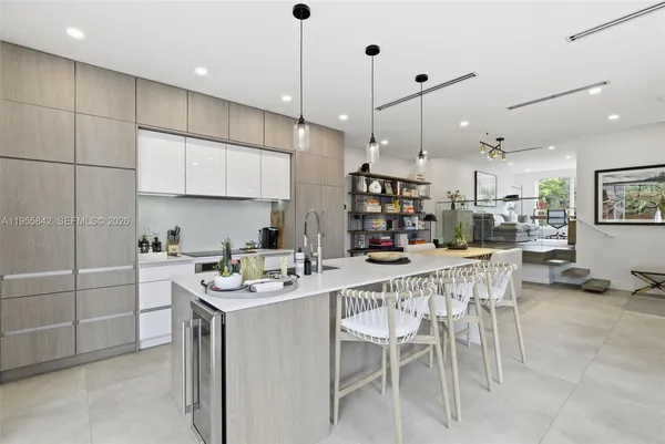 a kitchen with a table chairs microwave and cabinets