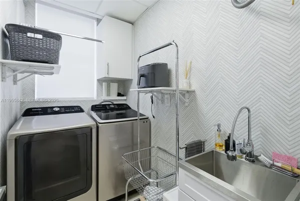 a kitchen with a sink cabinets and stainless steel appliances