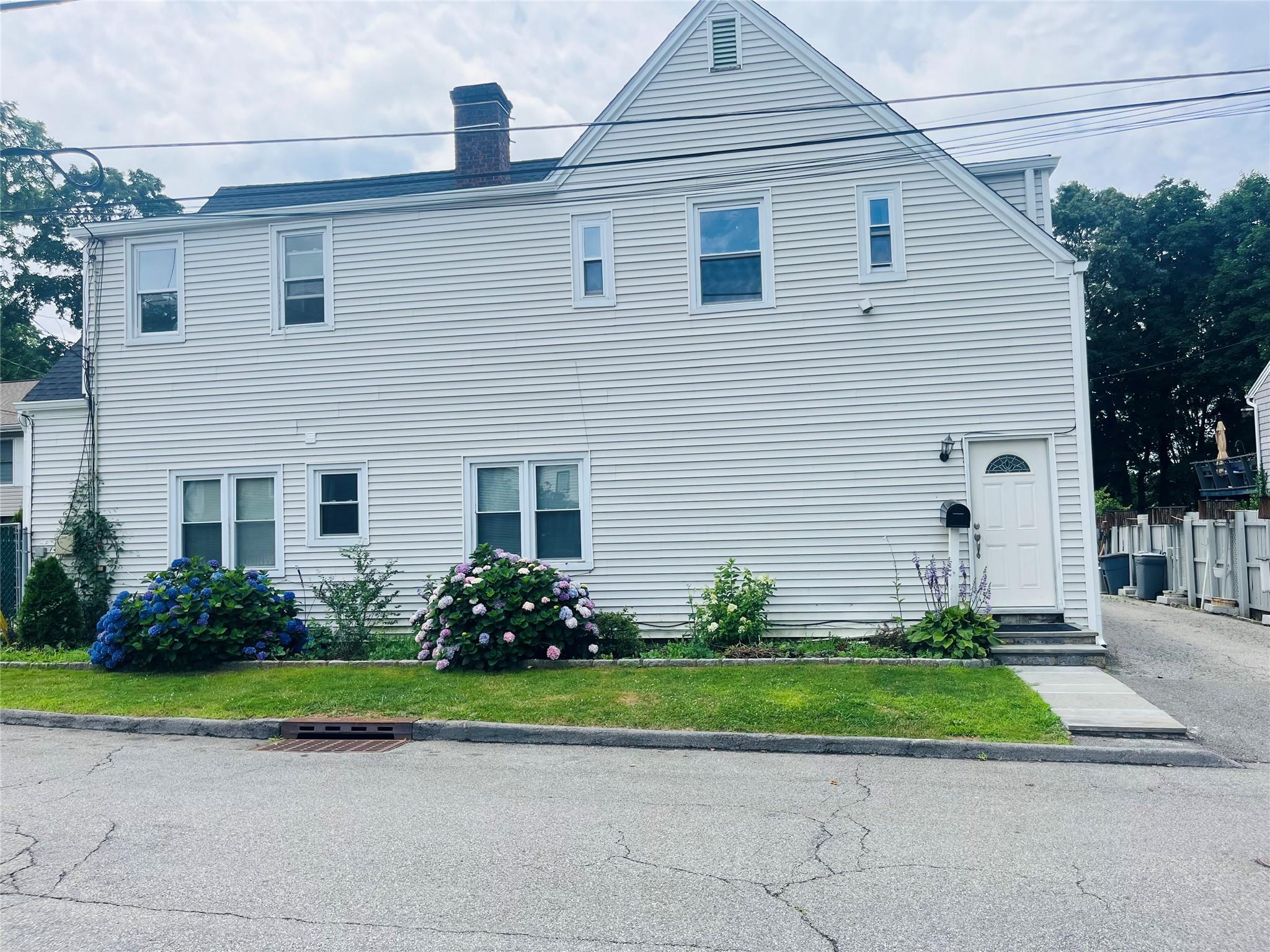 231 Eastern Avenue, Unit 2 Ossining, NY 10562 - Photo 1 of 1 a front view of a house with a garden