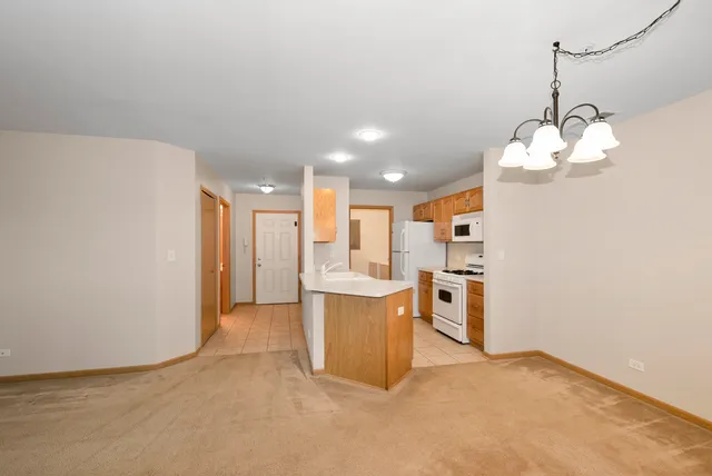 a view of a kitchen with a sink and a refrigerator