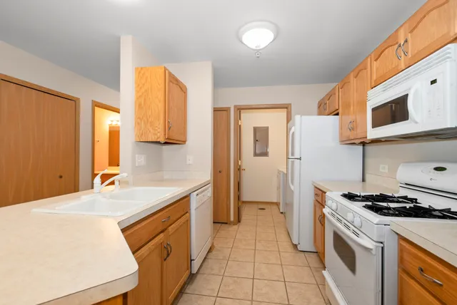 a kitchen with a sink stove and cabinets