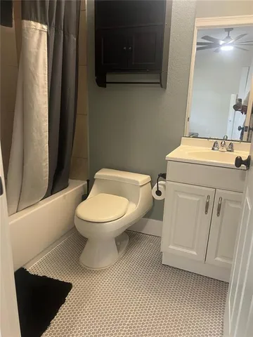 a white toilet sitting next to a bathroom sink
