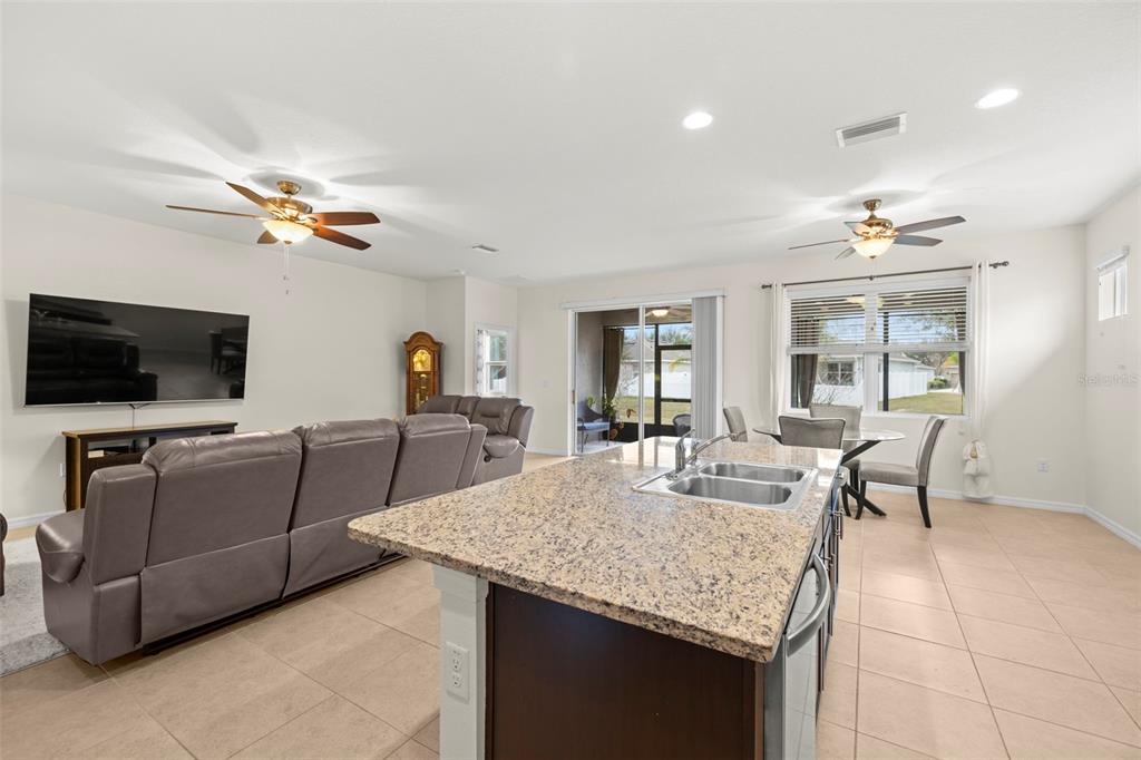 13562 Paddington Way Spring Hill, FL 34609 - Photo 12 of 39 a living room with furniture and a flat screen tv