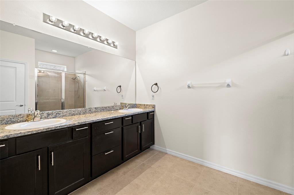 13562 Paddington Way Spring Hill, FL 34609 - Photo 19 of 39 a bathroom with a double vanity and a mirror