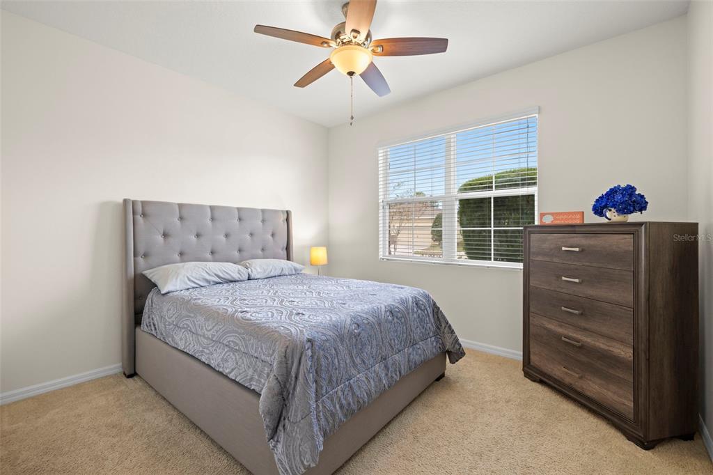 13562 Paddington Way Spring Hill, FL 34609 - Photo 22 of 39 a bedroom with a bed and a window