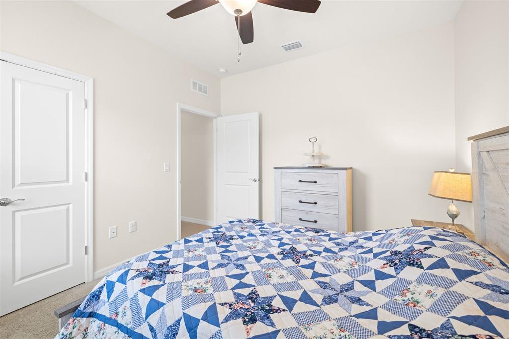 13562 Paddington Way Spring Hill, FL 34609 - Photo 26 of 39 a bedroom with a bed and a cabinets