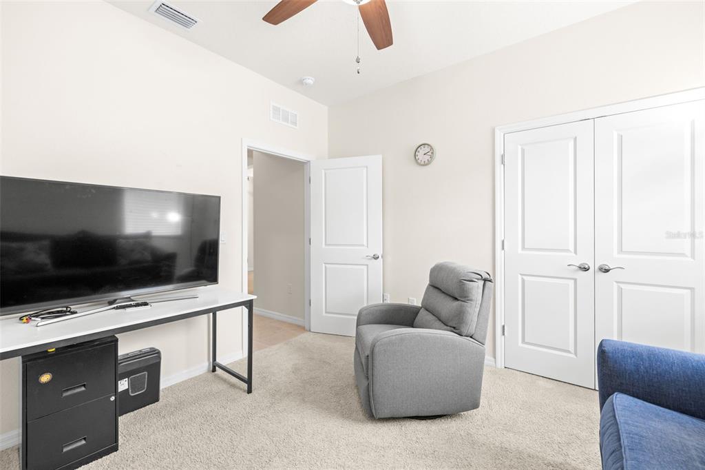 13562 Paddington Way Spring Hill, FL 34609 - Photo 28 of 39 a living room with furniture and a flat screen tv