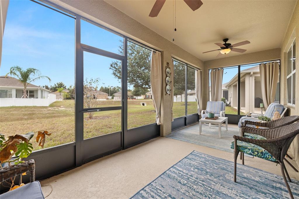 13562 Paddington Way Spring Hill, FL 34609 - Photo 30 of 39 a living room with furniture and large windows
