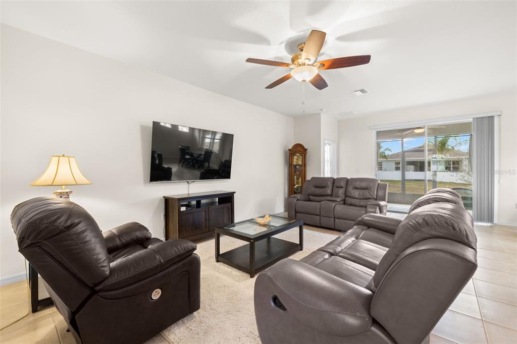 13562 Paddington Way Spring Hill, FL 34609 - Photo 4 of 39 a living room with furniture and a flat screen tv