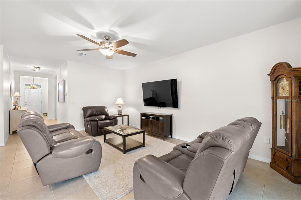 13562 Paddington Way Spring Hill, FL 34609 - Photo 6 of 39 a living room with furniture and a flat screen tv