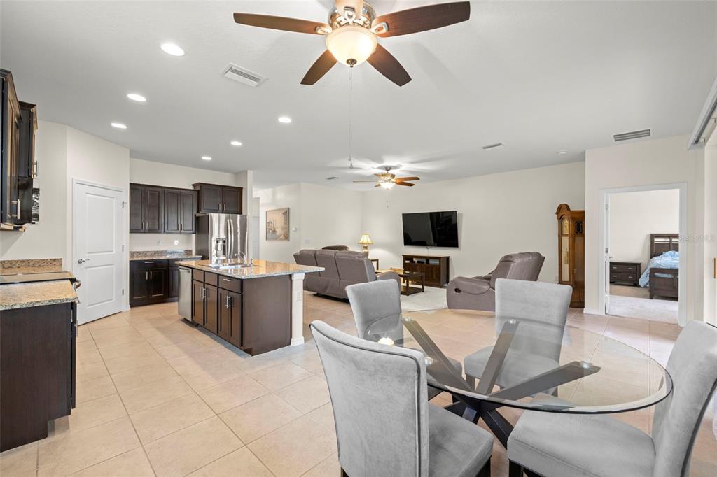 13562 Paddington Way Spring Hill, FL 34609 - Photo 8 of 39 a living room with furniture and a flat screen tv