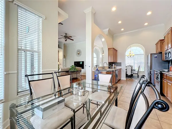 a view of a dining room with furniture a chandelier and wooden floor