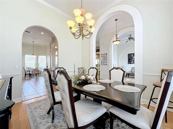 a view of a dining room with furniture and a chandelier
