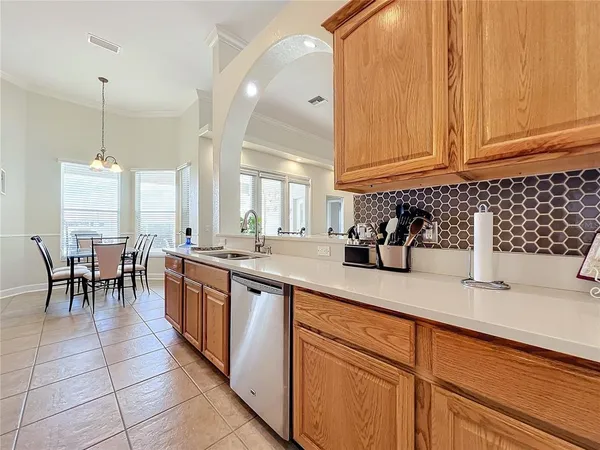 a kitchen with stainless steel appliances granite countertop a sink a stove and cabinets