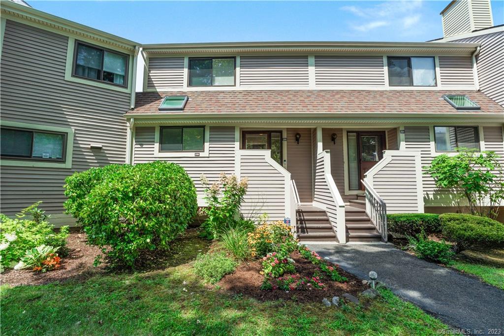 286 Opening Hill Road, Unit 286 Branford, CT 06405 - Photo 1 of 1 a front view of a house with a yard and outdoor seating
