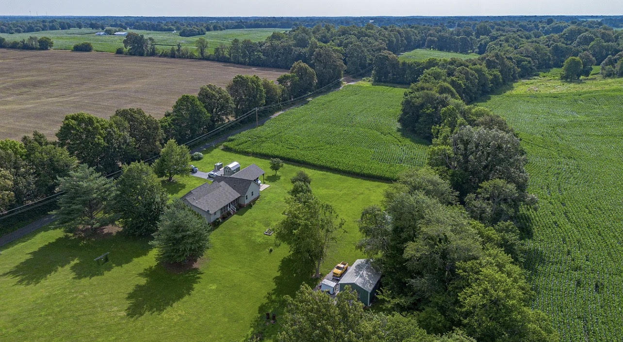 Drone view of home and 3.98 acres