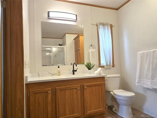a bathroom with a double vanity sink toilet and a mirror