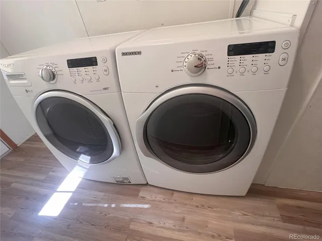 a view of washer and dryer with kitchen in the background