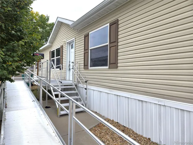 a view of a house with wooden deck