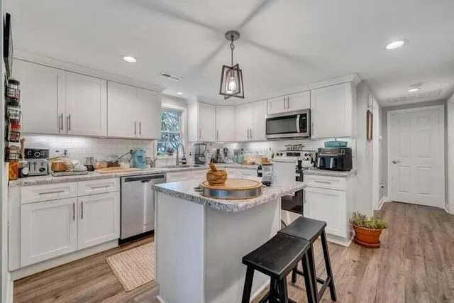 a kitchen with a stove a sink and cabinets