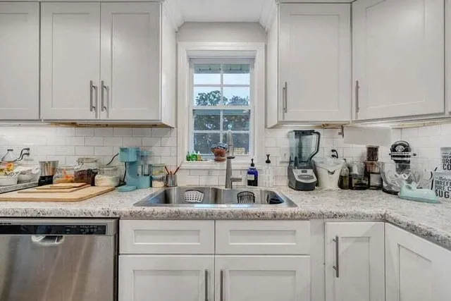 a bedroom with a bed and a tv on the dresser