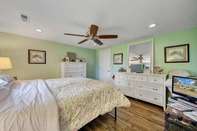 a white toilet sitting next to a shower curtain