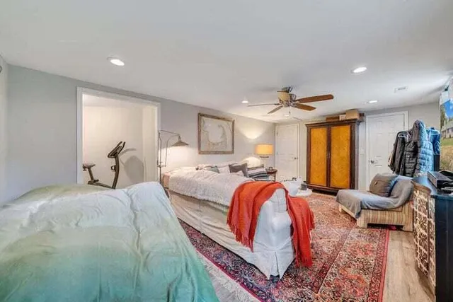 a bedroom with a large bed and a chandelier