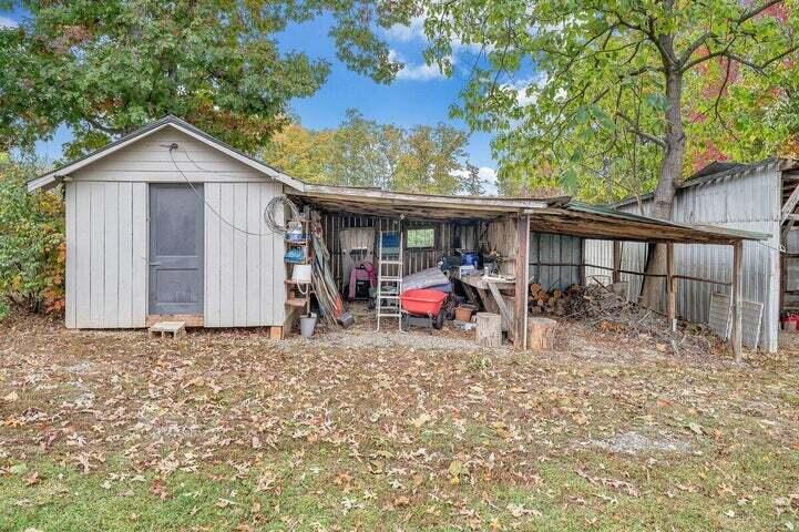 945 Burnt Chimney Road Wirtz, VA 24184 - Photo 41 of 54 a view of a wooden house with large trees and a wooden fence