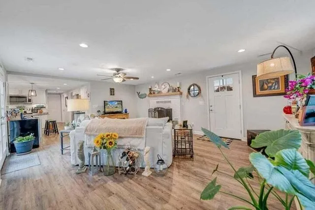 a living room with furniture and a chandelier