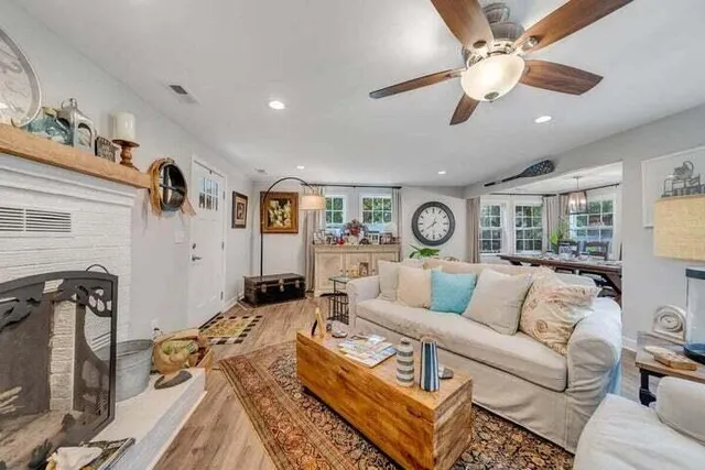 a dining room with furniture a chandelier and wooden floor