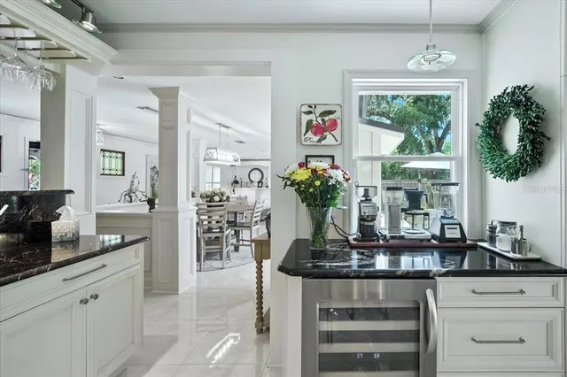 a living room with furniture a fireplace and a large window