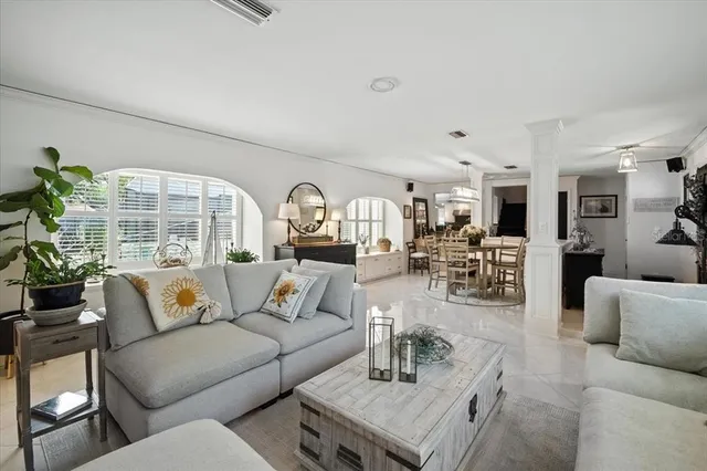 a bedroom with a bed a mirror and a night stand