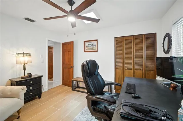 a view of house with a yard and sitting area