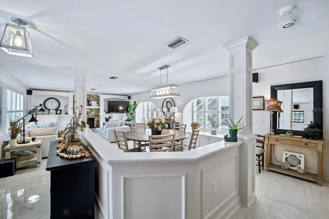 a view of a dining room with furniture a chandelier and window