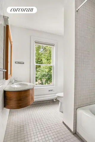 a bedroom with bed and window