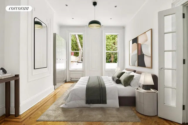 a view of a livingroom with furniture a fireplace and large windows