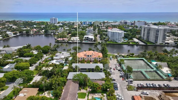 an aerial view of lake and residential houses with outdoor space and ocean view