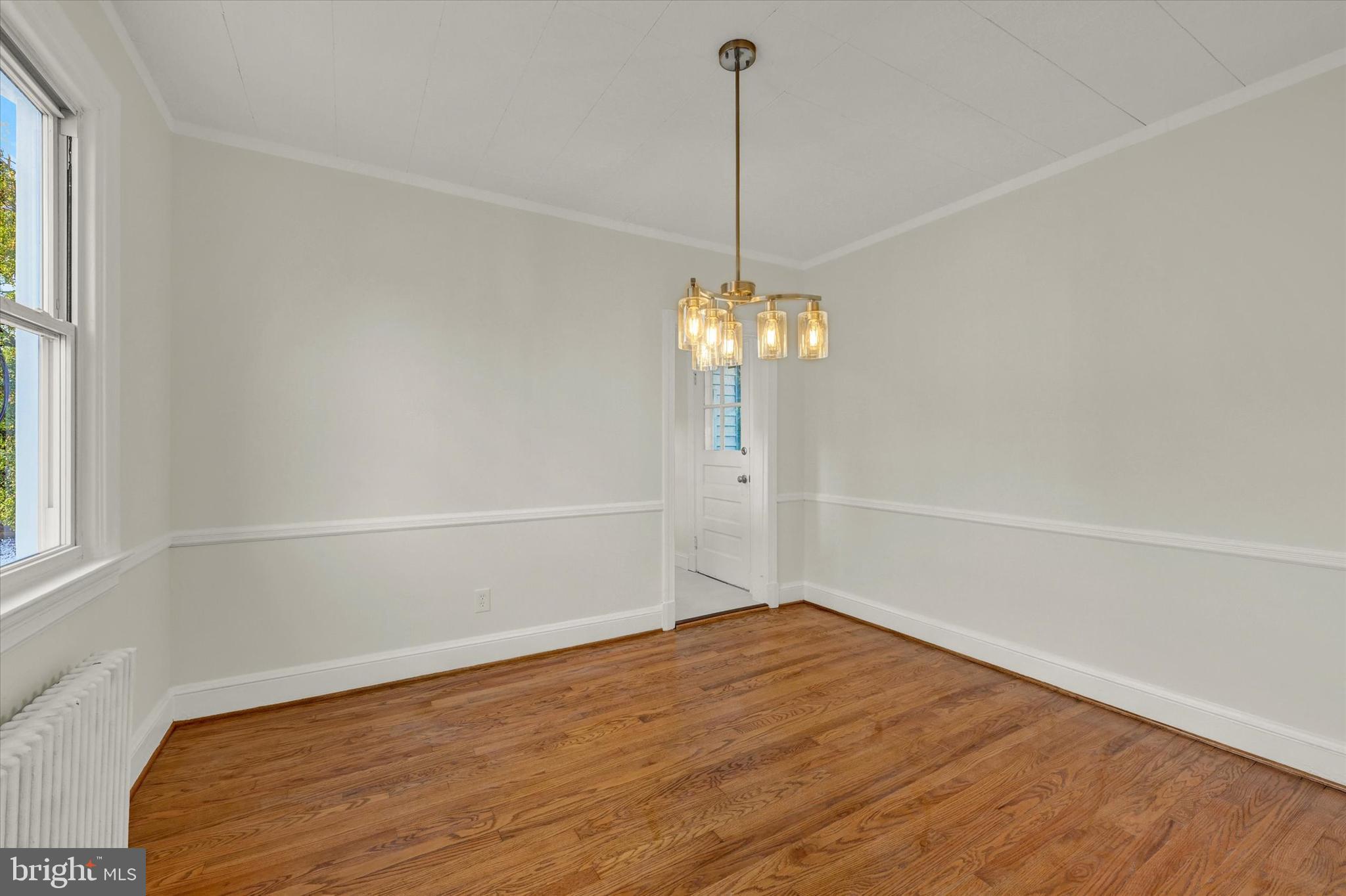 1032 Elm Ridge Avenue Baltimore, MD 21229 - Photo 13 of 28 a view of empty room with wooden floor and fan